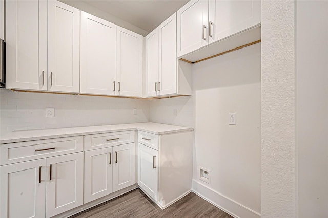 interior space with white cabinets and dark hardwood / wood-style floors