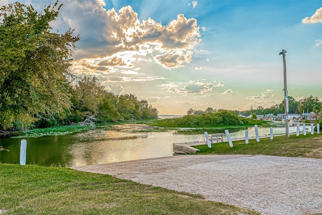 view of property's community with a dock and a water view