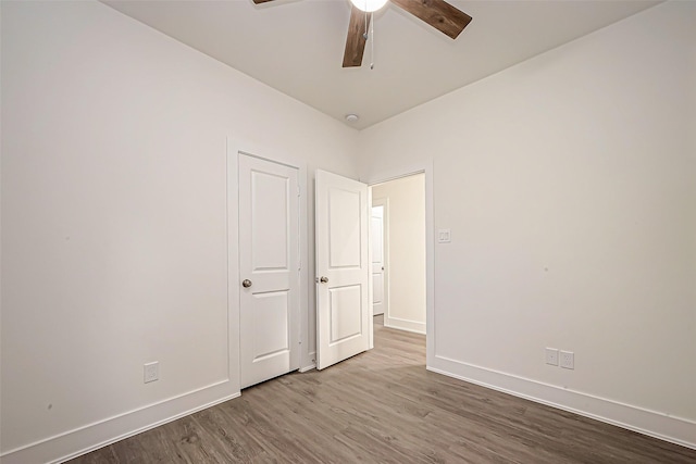 unfurnished bedroom featuring hardwood / wood-style flooring and ceiling fan