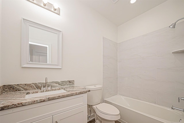 full bathroom featuring vanity, toilet, and tiled shower / bath