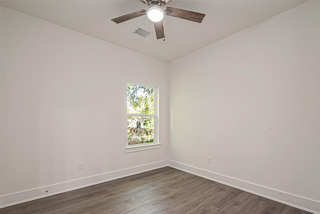 spare room with ceiling fan and dark hardwood / wood-style flooring