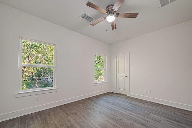 spare room featuring dark hardwood / wood-style floors and ceiling fan