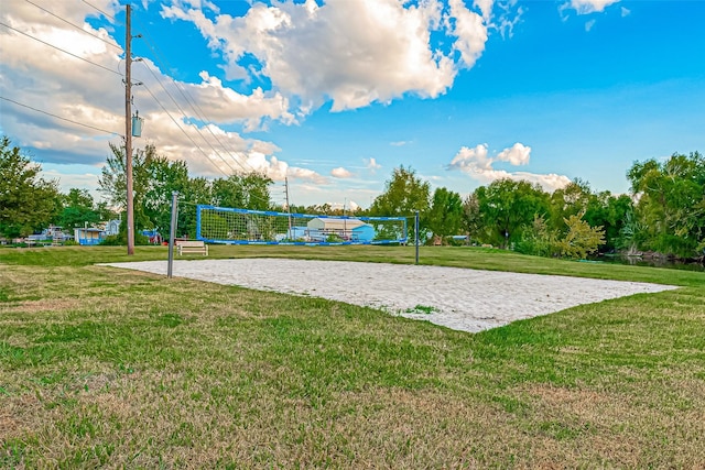 view of home's community with volleyball court and a lawn