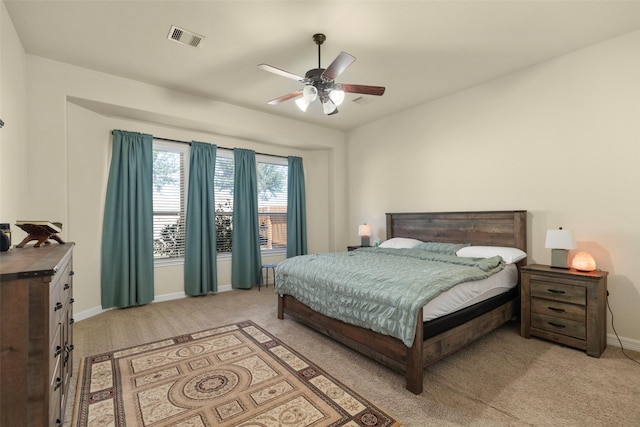 bedroom with ceiling fan and light colored carpet