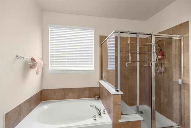 bathroom featuring separate shower and tub