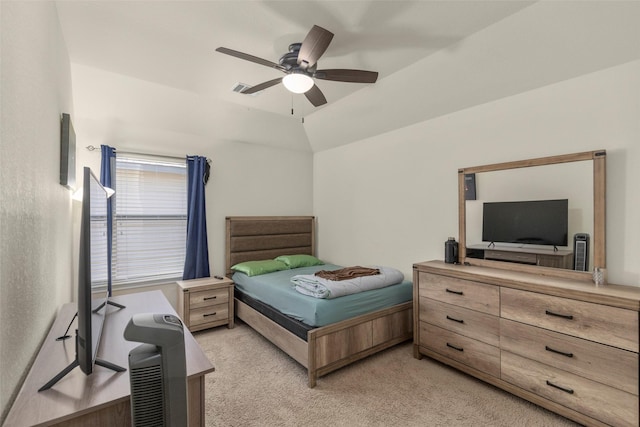 carpeted bedroom with vaulted ceiling and ceiling fan