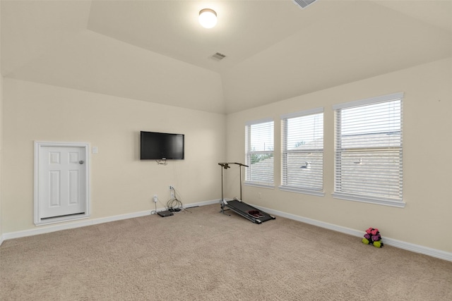 workout area featuring carpet and vaulted ceiling