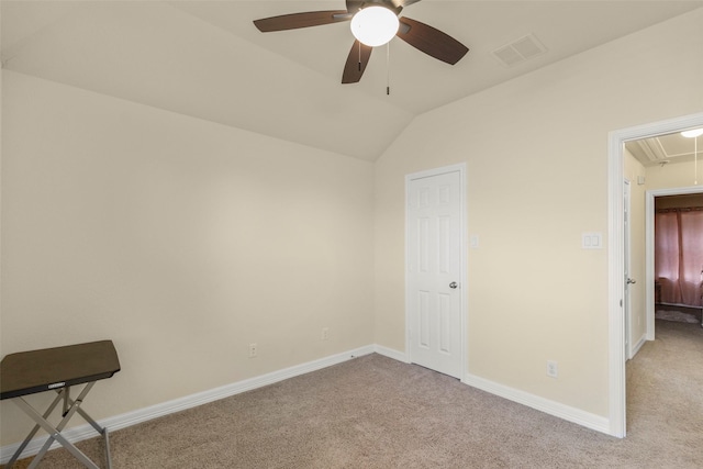 carpeted spare room with ceiling fan and vaulted ceiling