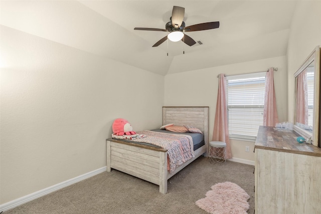 carpeted bedroom with ceiling fan and vaulted ceiling