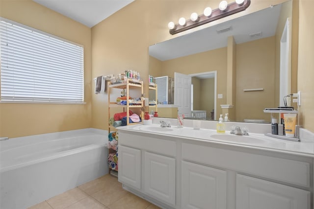 bathroom with tile patterned floors, a bathtub, and vanity