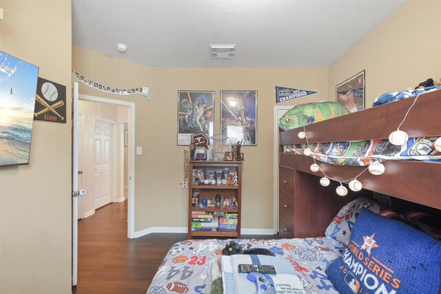 bedroom with dark wood-type flooring