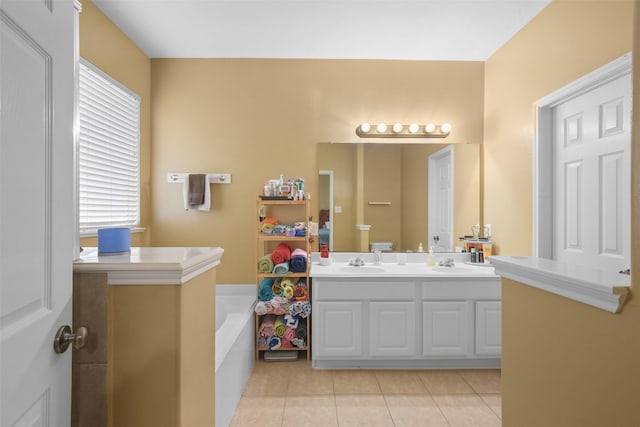 bathroom with tile patterned flooring, vanity, and a washtub