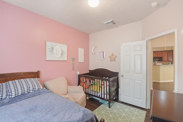 bedroom with wood-type flooring