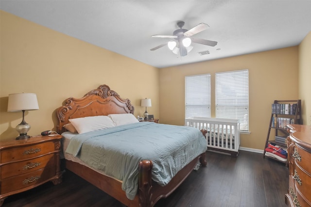 bedroom with dark wood-type flooring and ceiling fan