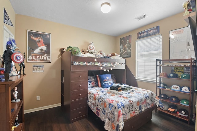 bedroom featuring multiple windows and dark hardwood / wood-style flooring