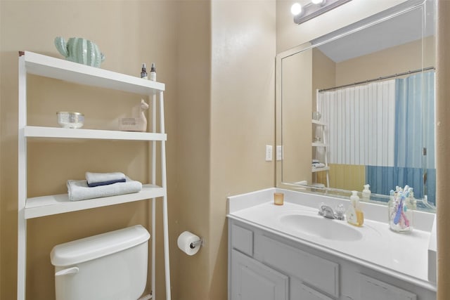 bathroom featuring vanity and toilet