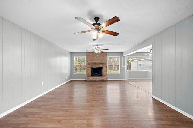 unfurnished living room with a fireplace and light hardwood / wood-style floors