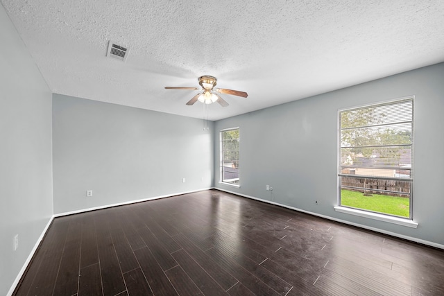 empty room with ceiling fan, a textured ceiling, and dark hardwood / wood-style flooring