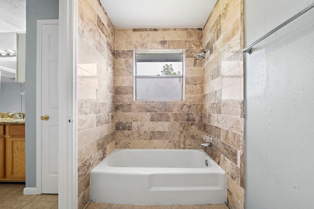 bathroom with vanity and tiled shower / bath combo