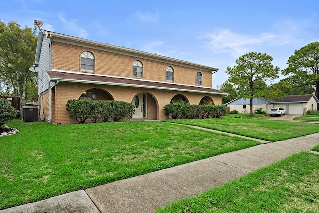 view of front facade featuring a front lawn and central air condition unit