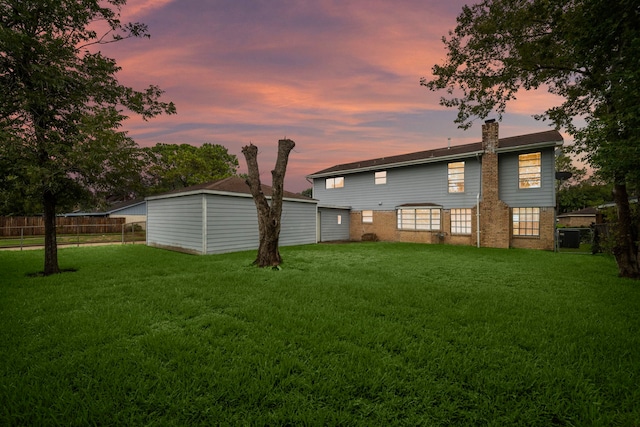 back house at dusk with a yard