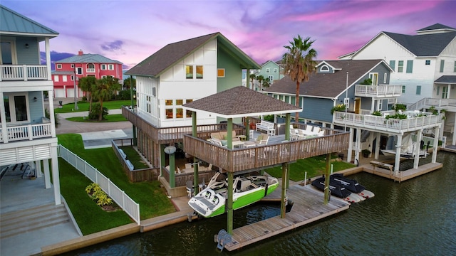 dock area featuring a residential view and a water view