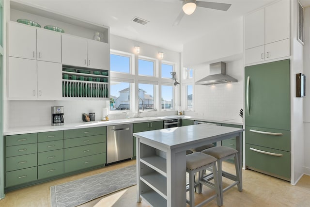 22823 Chiquita St, Galveston, TX 77554 - kitchen featuring green cabinets, visible vents, dishwasher, wall chimney range hood, and fridge