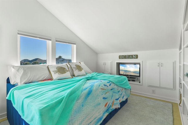 bedroom with baseboards and lofted ceiling