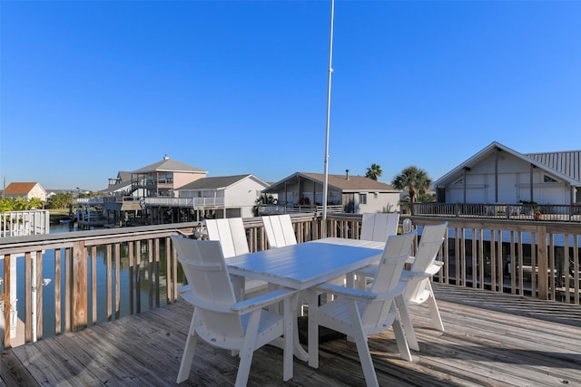 22823 Chiquita St, Galveston, TX 77554 - wooden terrace with a residential view, outdoor dining area, and a water view