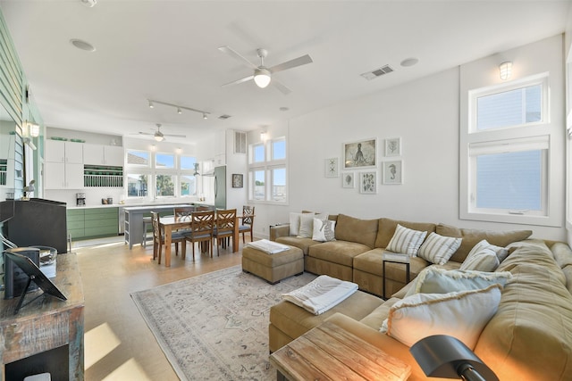 living area featuring visible vents, track lighting, and a ceiling fan