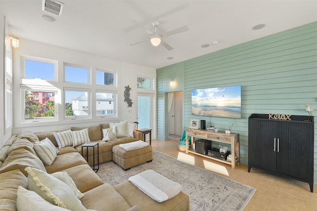 living room featuring visible vents and a ceiling fan