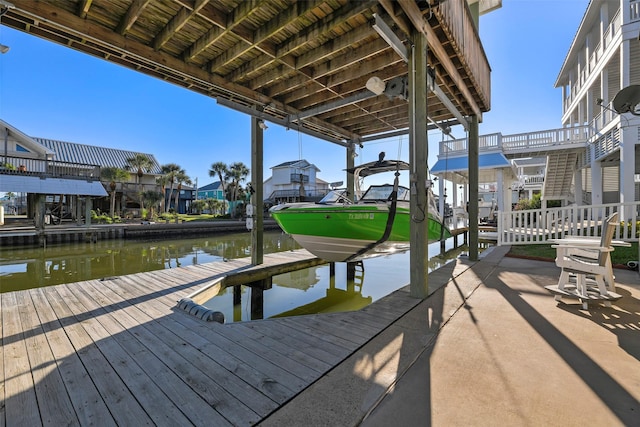 view of dock featuring a residential view and a water view