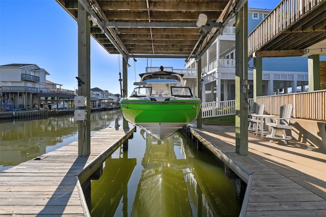 dock area featuring boat lift and a water view