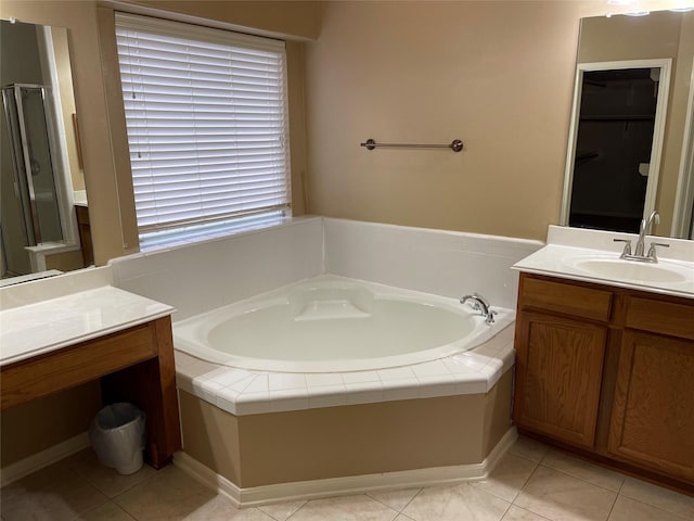 bathroom featuring tile patterned flooring, shower with separate bathtub, and vanity