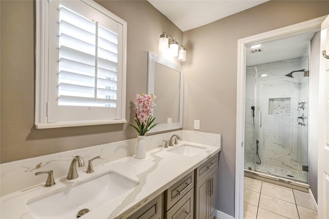 bathroom with vanity, walk in shower, tile patterned floors, and a wealth of natural light