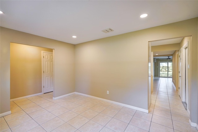 unfurnished room with ceiling fan and light tile patterned floors