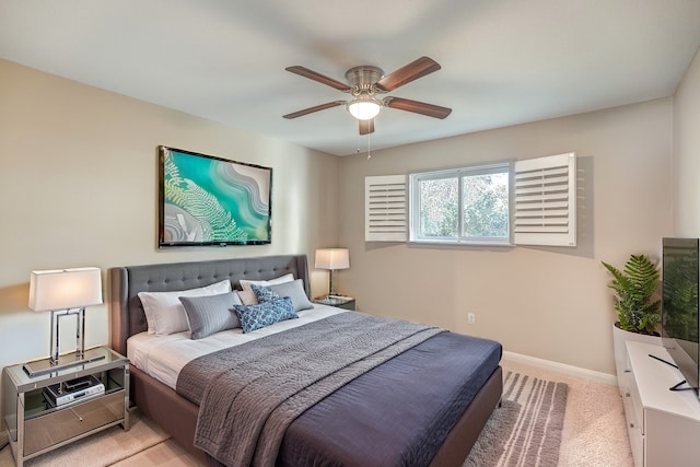 bedroom featuring ceiling fan and light carpet