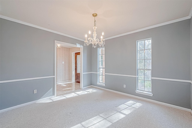 empty room with a notable chandelier, light colored carpet, ornamental molding, and a wealth of natural light