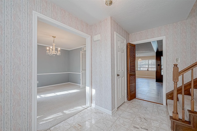 bathroom with ornamental molding and a notable chandelier