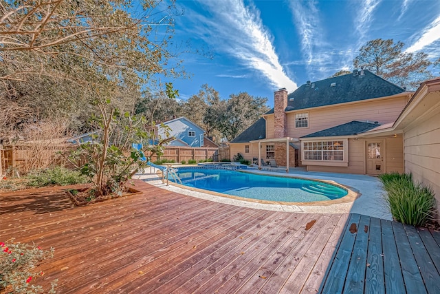 view of pool with a deck and a water slide