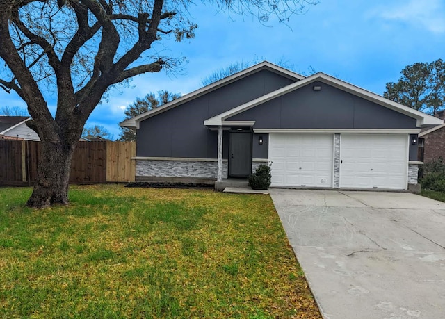 single story home with a front lawn and a garage