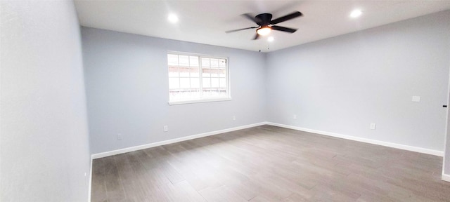 spare room featuring dark wood-type flooring and ceiling fan