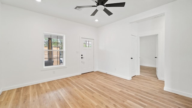 empty room featuring ceiling fan and light hardwood / wood-style flooring