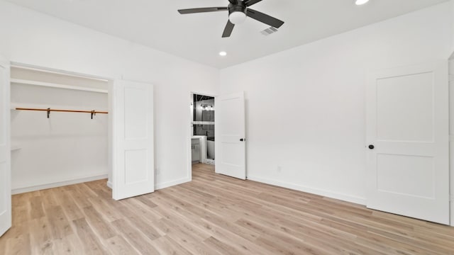 unfurnished bedroom with ceiling fan, light wood-type flooring, and a closet