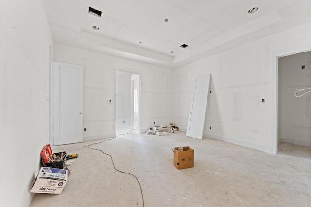 spare room with a raised ceiling