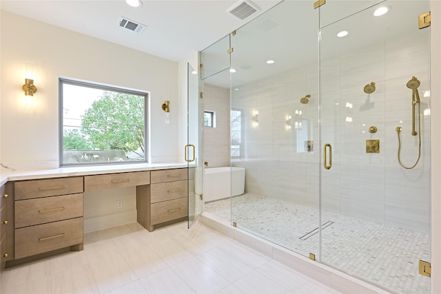 bathroom featuring a shower with shower door, vanity, and tile patterned floors