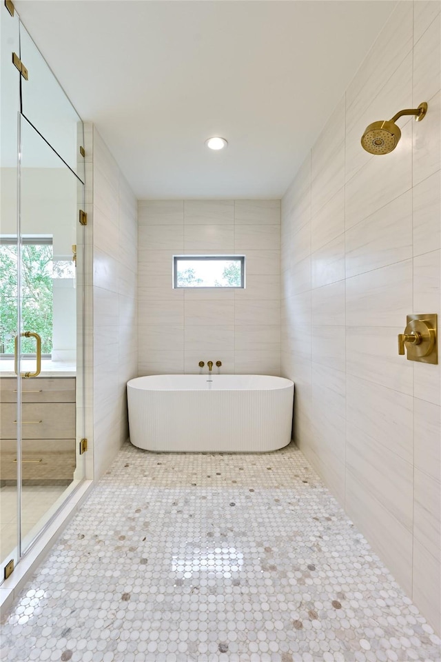 bathroom featuring plenty of natural light, tile patterned floors, and independent shower and bath