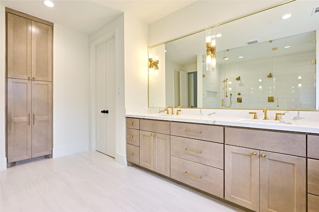 bathroom with tile patterned flooring, a shower with door, and vanity