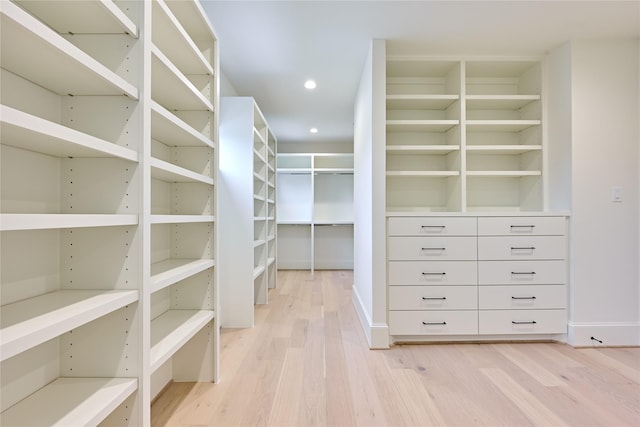 spacious closet featuring light hardwood / wood-style floors