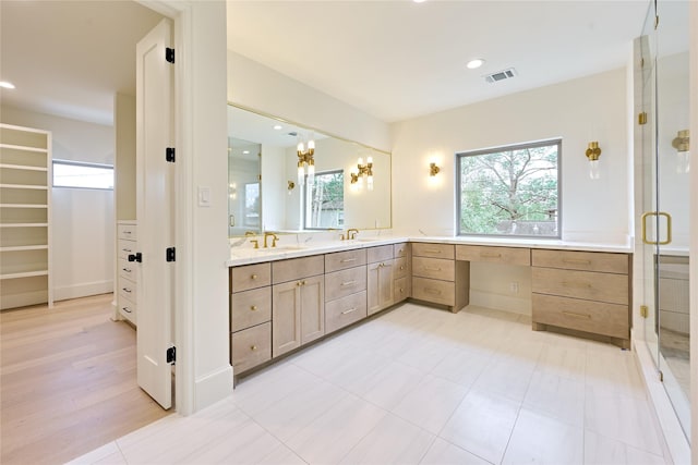 bathroom featuring walk in shower and vanity